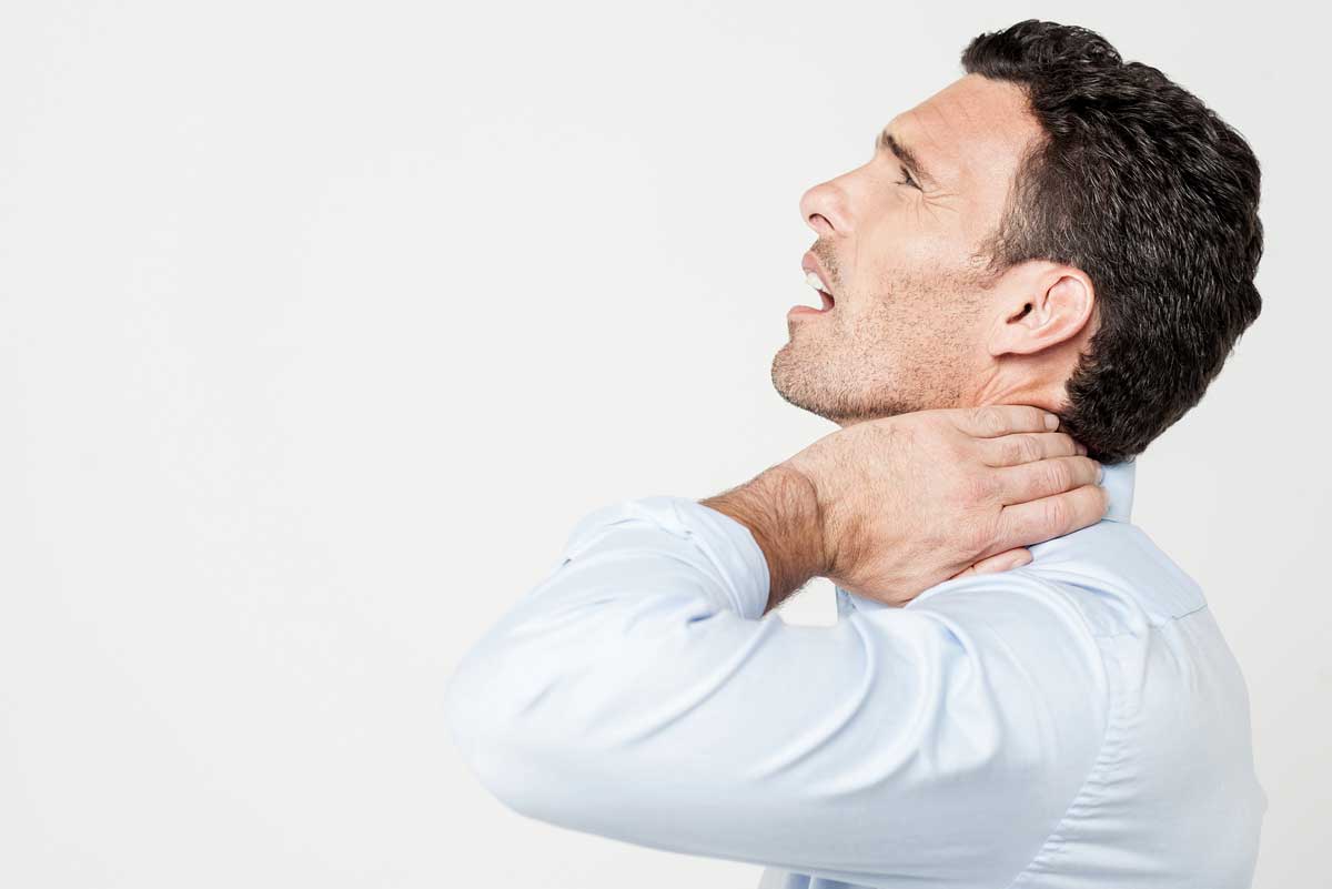 man holding his neck in pain