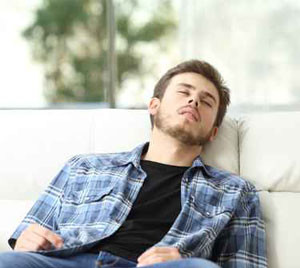 man sleeping on couch