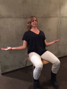 woman in chair performing brueggers exercise and stretch
